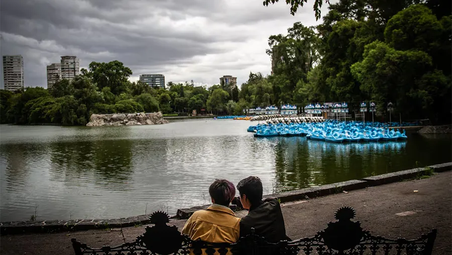 Una pareja toma un descanso frente al lago de Chapultepec, en Ciudad de México.