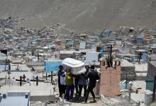 Miembros de la familia llevan el ataúd de un hombre que murió de la enfermedad del coronavirus en un cementerio, en Lima, Perú, el 27 de enero de 2021.